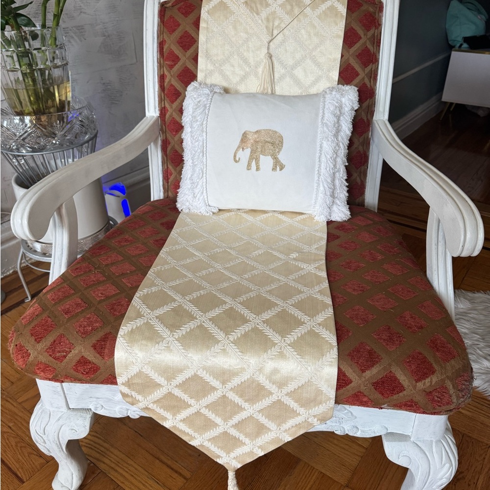 Elegant Red and Cream Armchair with Elephant Pillow